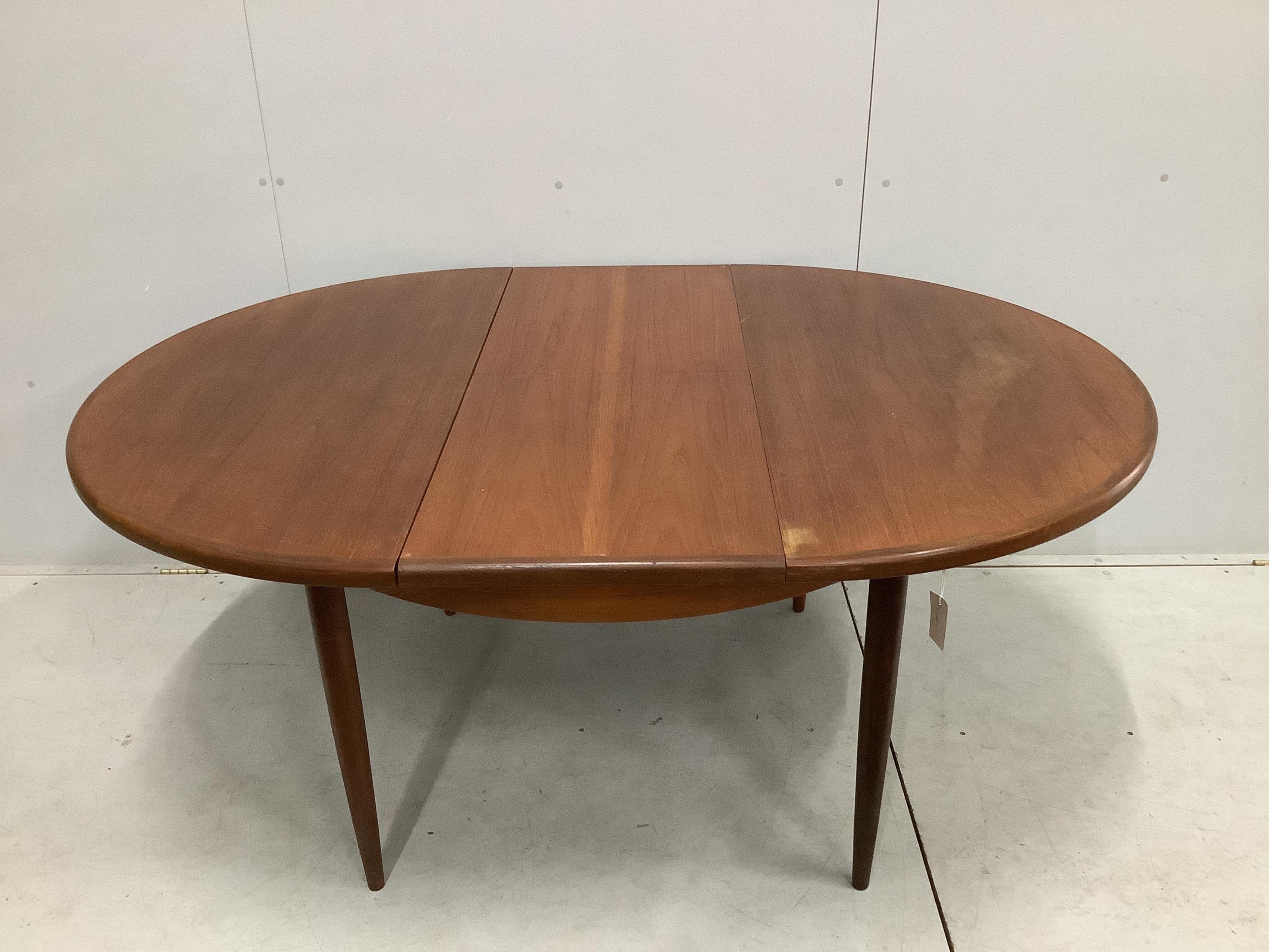 A G plan extending dining table, width 169cm extended, depth 122cm, height 72cm. Condition - fair to good